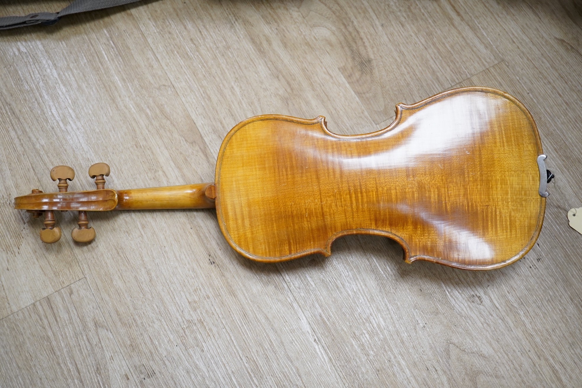 Two cased three quarter size violins, one labelled the London violin Co Ltd, length of back 33.5cm. Condition - both scratched